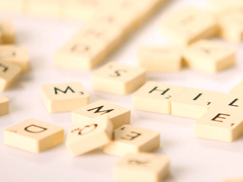 Spielsteine tragen einzelne Buchstaben und liegen durcheinander. Spielsteine tragen einzelne Buchstaben und liegen durcheinander.